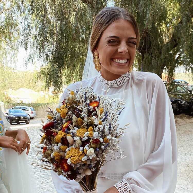 Bride with 3-circle Earring and Flower Arrangement at Wedding